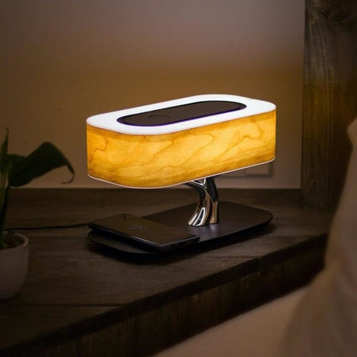 Lampe TREE en bois de cerisier avec base de chargement par induction pour smartphone, haut-parleur Bluetooth intégré et réglage de luminosité tactile. Dimensions : H 23 x L 34 x PR 20 cm.